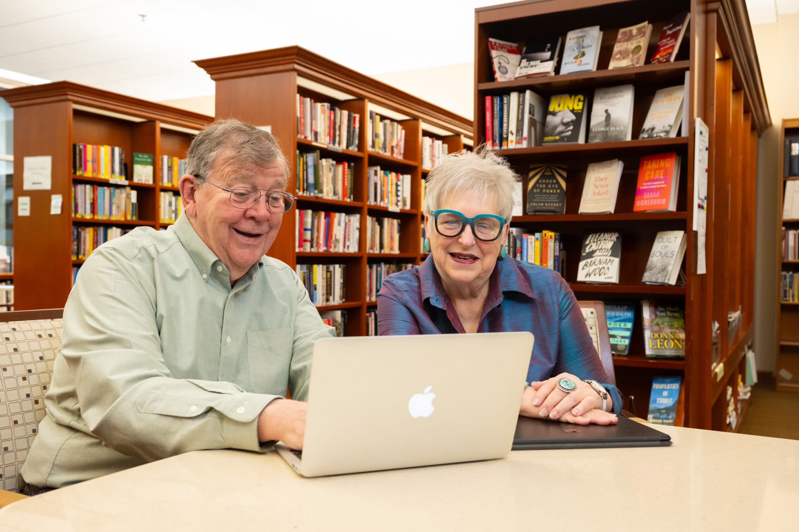 Holladay Park Plaza residents Ted and Punkin Schenck happily look at a computer in a library.